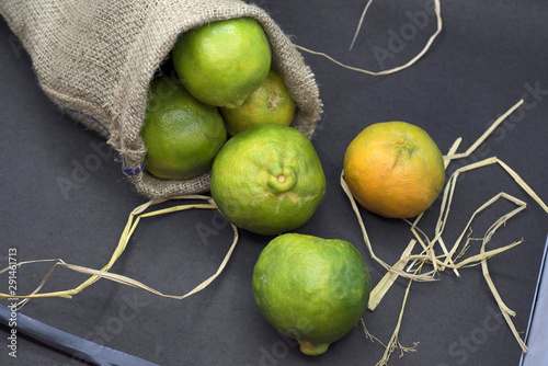 Green orange in jute bag photo