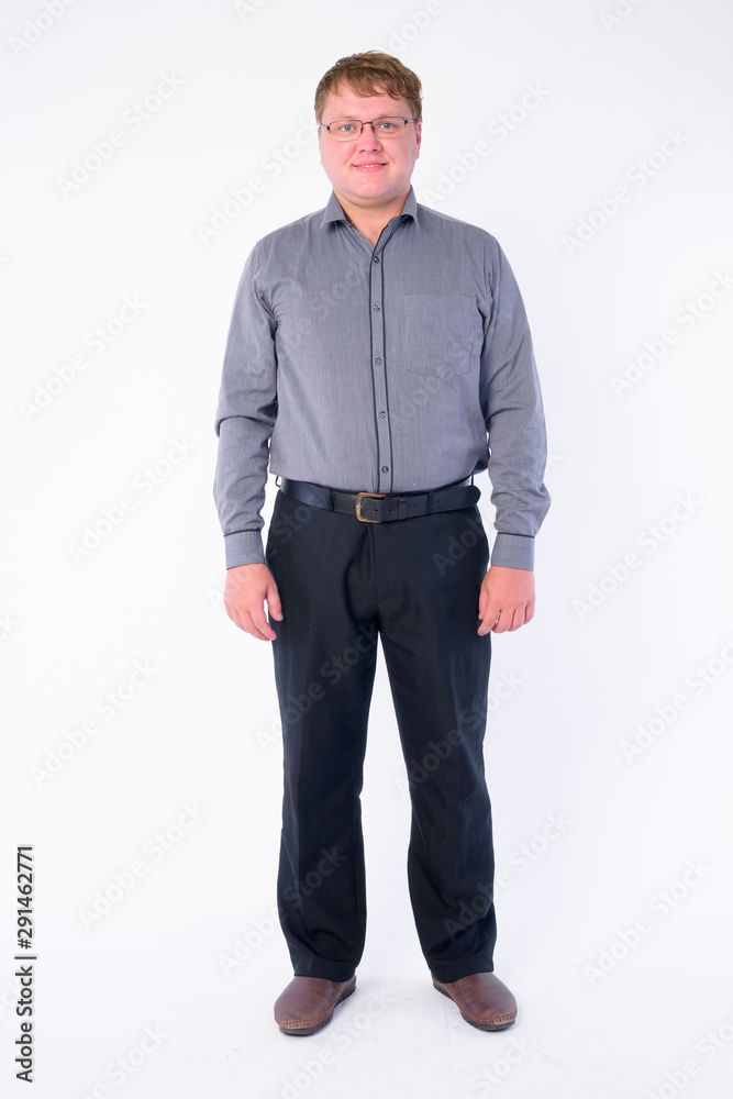 Full body shot of happy overweight businessman with eyeglasses smiling Full body shot of happy overweight businessman with eyeglasses smiling