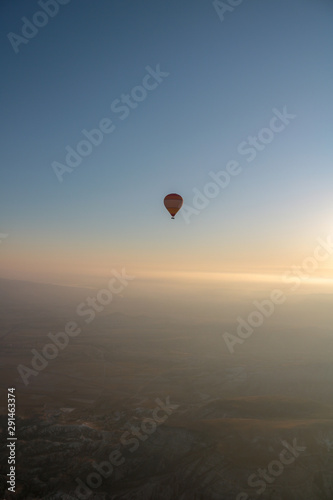hot air balloon isolated on the blue sky at sunrise