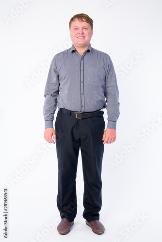 Full body shot of happy overweight businessman smiling