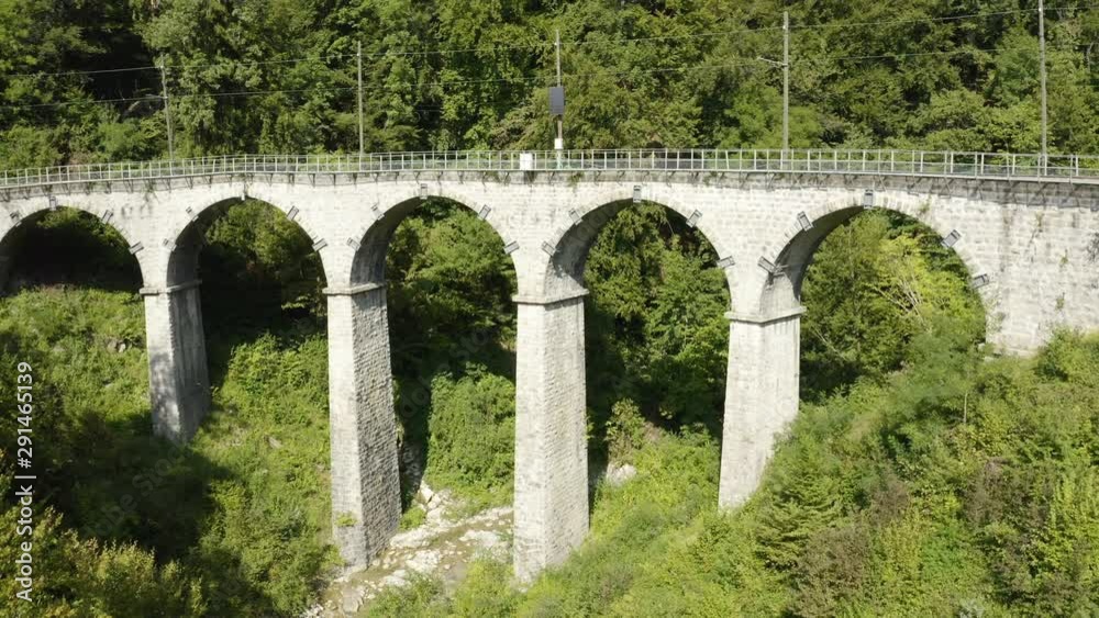 Aerial shot climbing above old Blonay-Chamby railway bridge, camera tilting down while climbing. Montreux-Riviera area, Switzerland