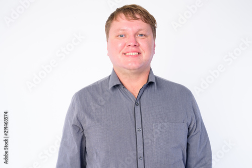 Face of happy overweight businessman smiling and looking at camera