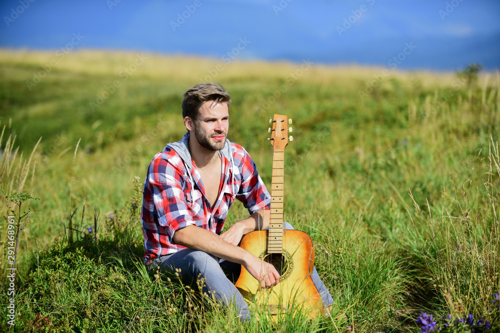 start the music. sexy man with guitar in checkered shirt. cowboy man with  acoustic guitar player. country music song. hipster fashion. happy and  free. western camping and hiking foto de Stock