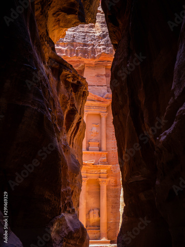 Front facade of the treasury temple of Petra, Jordan, seen from dark sandstone cliffs