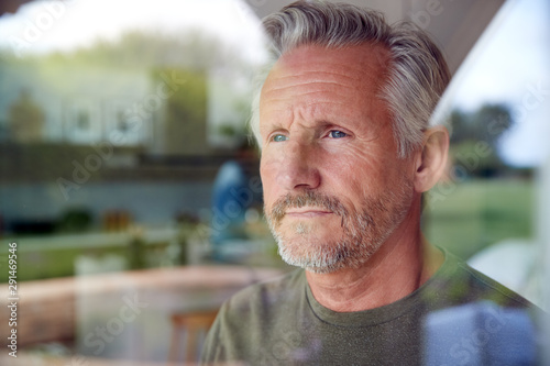 Photos Senior Man Standing And Looking Out Of Kitchen Door Viewed Through Window