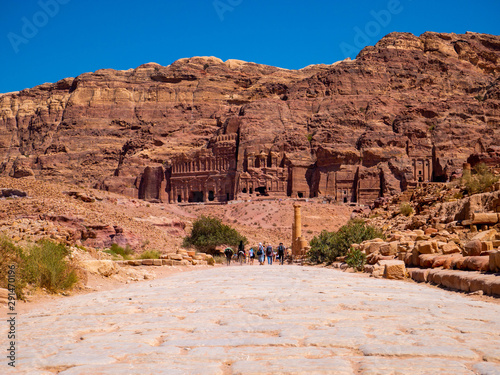 Cobblestone street leading to a mountain full of temples carved into sandstone, historic monument, ruin in the desert of the historic site of Petra, Jordan