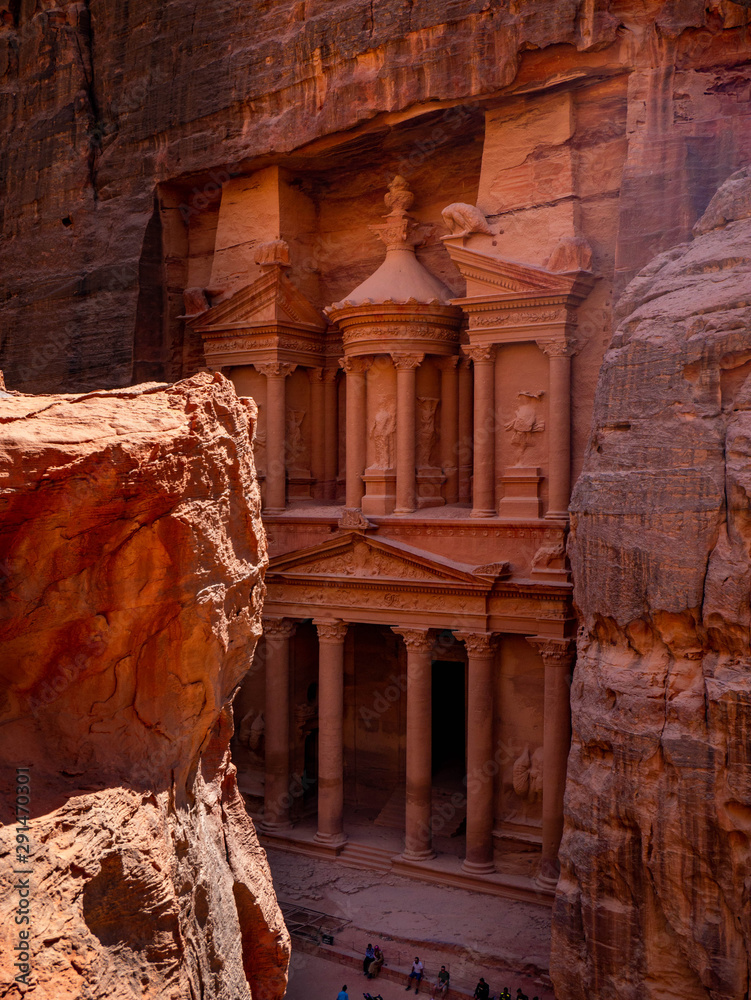 Front facade of the treasury temple of Petra, Jordan, seen from the perspective of a high stone plateau