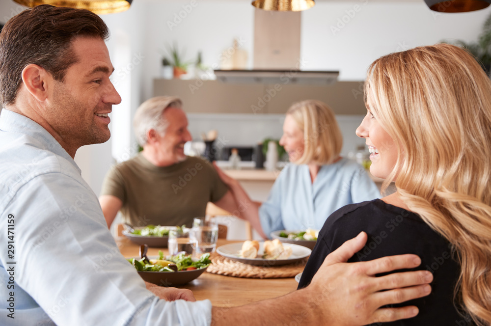 Introducing Boyfriend Or Girlfriend To Senior Parents At Meal Around Table At Home Together