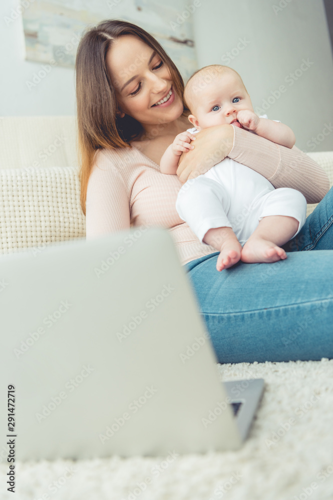 selective focus of mother holding her child in apartment selective focus of mother holding her child in apartment