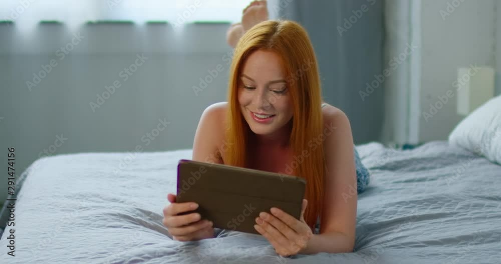 Beautiful woman, browsing in tablet computer, gadget, looking through social media news, having nice weekend morning at home. Caucasian. 4K, Middle plan, camera movement left to right, RED camera. Beautiful woman, browsing in tablet computer, gadget, looking through social media news, having nice weekend morning at home. Caucasian. 4K, Middle plan, camera movement left to right, RED camera.