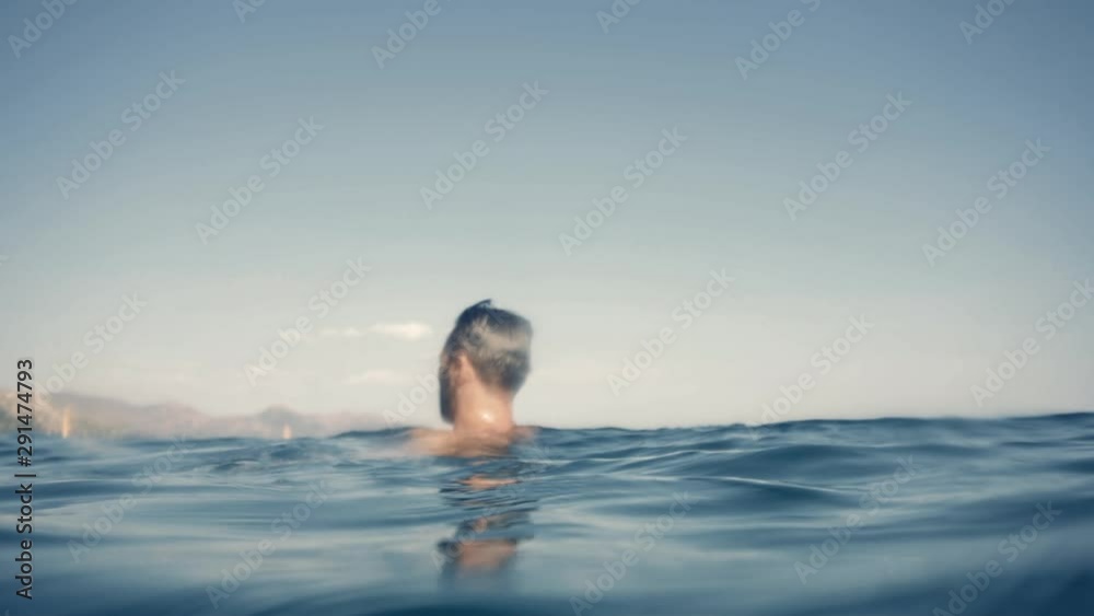 Swimming Man On Blue Sea Underwater.Underwater Man Swimming In Slow Motion With Air Bubbles.Air Bubbles In Water.Water Drops Falling And Splashing On Glassy Water Surface Blue Ocean. Swimming Man On Blue Sea Underwater.Underwater Man Swimming In Slow Motion With Air Bubbles.Air Bubbles In Water.Water Drops Falling And Splashing On Glassy Water Surface Blue Ocean.