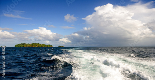 Wide angle shot on the open sea with blue and tourquoise oceans's surface with waves and blue sky with cloudsduring a boat trip around the wonderful island Samana, Dominican Republic in the Caribbean. © doris oberfrank-list