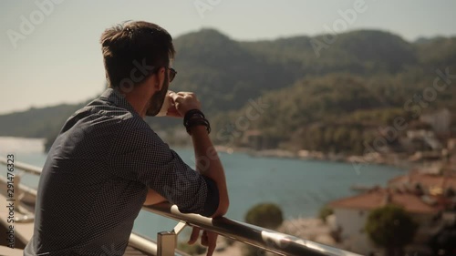 Wallpaper Mural Attractive Italian Man Stay On Balcony Looking At Calm Sea And Drinking Tea.Guy Relaxing In Morning On Porch.Man Drinking Coffee On Porch And Looking At Sea.Lonely Romantic Man Rest And Looks At Ocean Torontodigital.ca