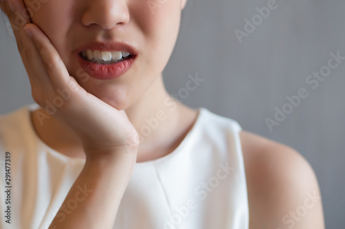woman with toothache; sick asian woman suffering from toothache, tooth decay, tooth sensitivity, cavity, dental care concept; young adult asian woman model photo