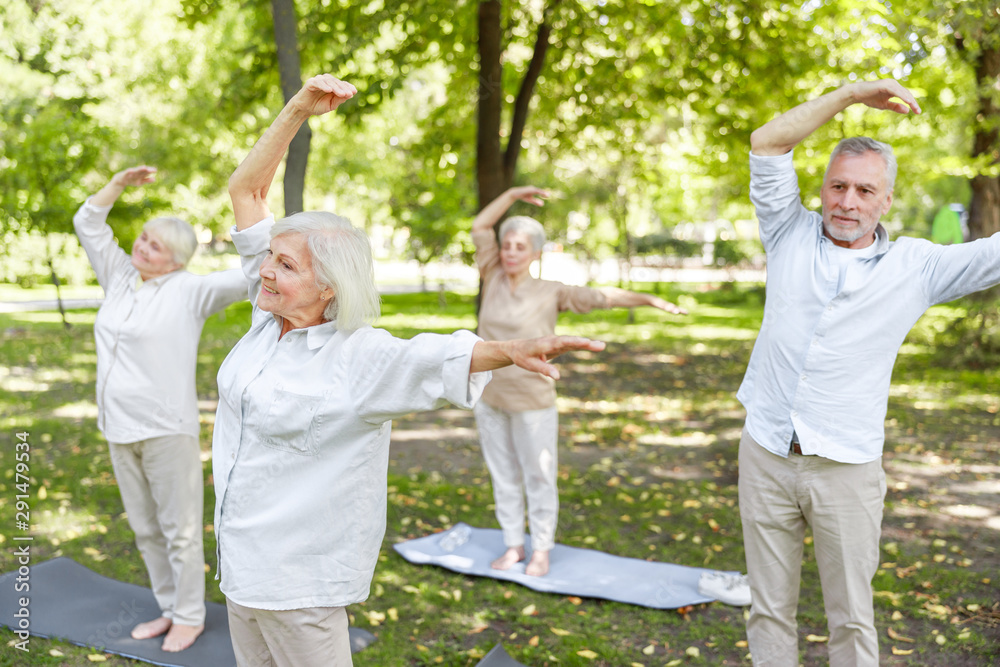 Joyful old people practicing chi kung in the park Joyful old people practicing chi kung in the park