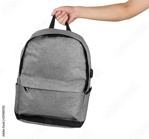Hand holding grey colour backpack isolated over white background