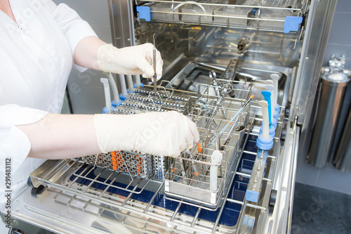 Sterilizing medical instruments in autoclave. Dental office