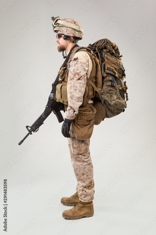 Portrait of a young American US Marine Corps soldier over grey background