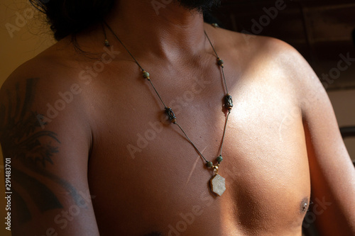 Hexagon agate druzi pendant necklace on dark skin male chest photo