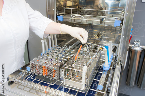 Sterilizing medical instruments in autoclave. Dental office