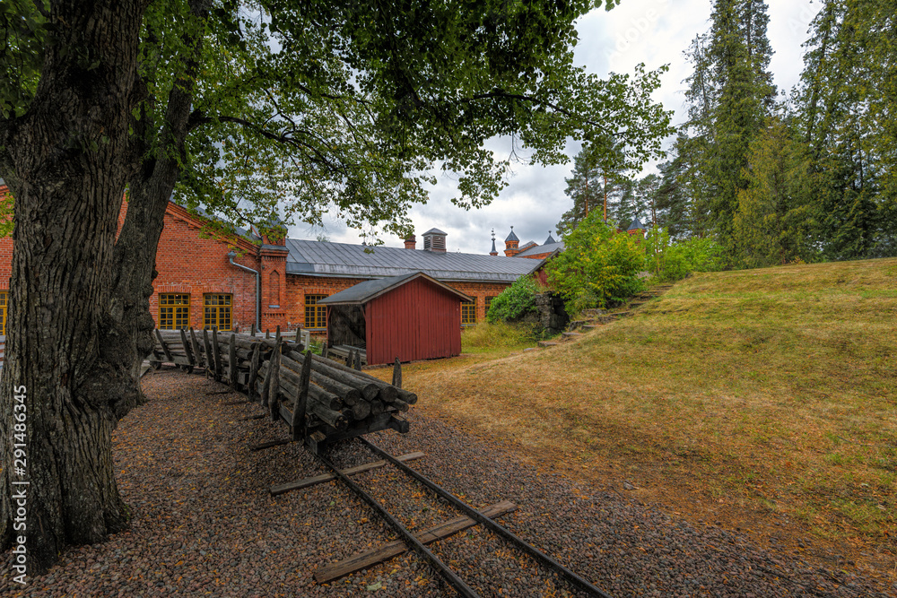 Bundles of logs hauled on the wagons along the rails to the building of the groundwood mill for processing into paper. Verla Groundwood and Board Mill - Museum. Finland.