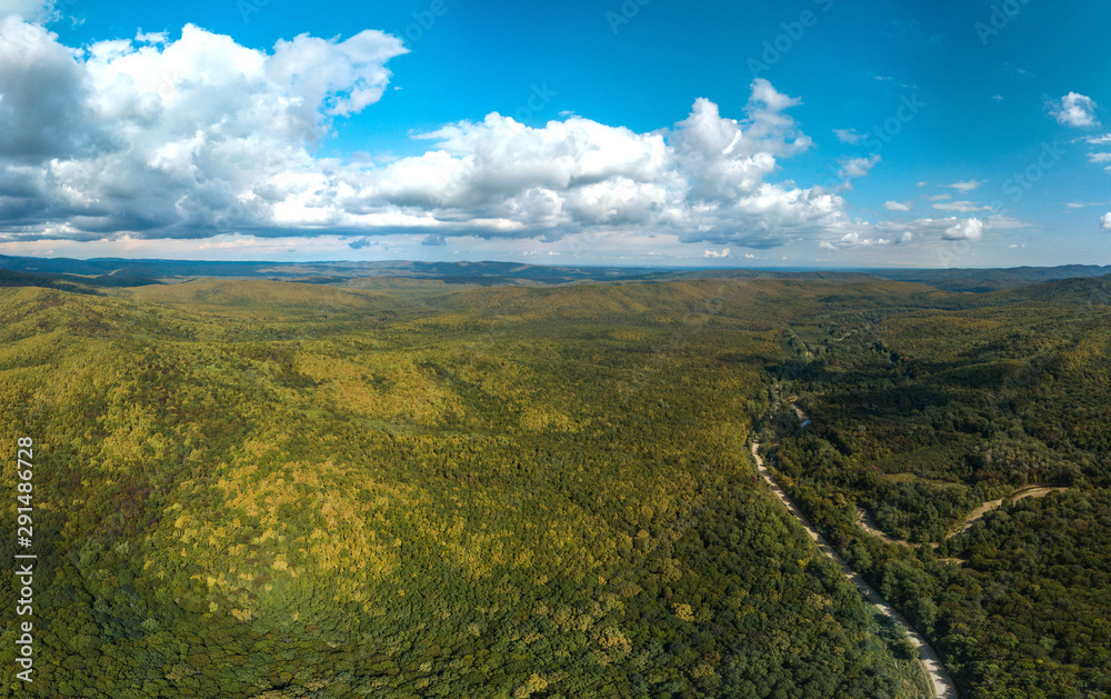Fototapeta premium above the road to the village of Mirny (Western Caucasus. South of Russia) in early autumn - in the mountains the higher. the leaves are yellower