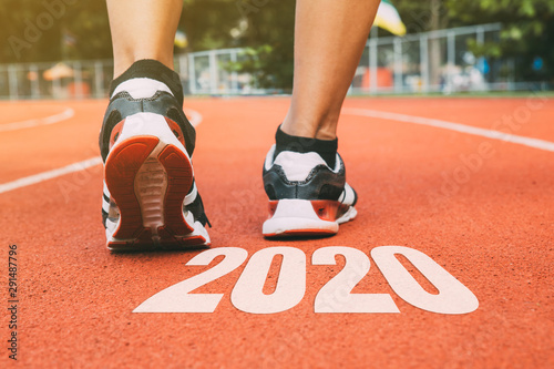 New Year 2020 Concept.Close up shot of Runner man feet running on running track