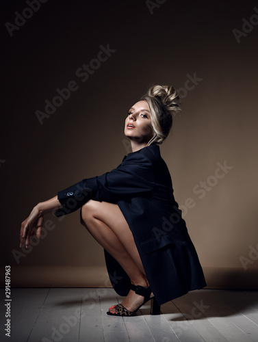 Принти на полотні Daring stylish young blonde woman with faux hawk in official mens jacket over he