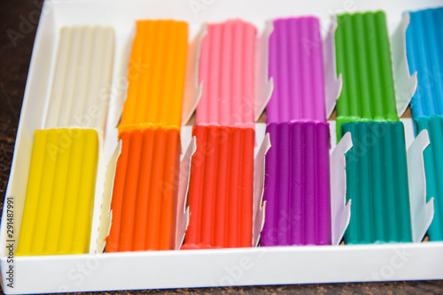 new packaging of multi-colored bright plasticine lies
