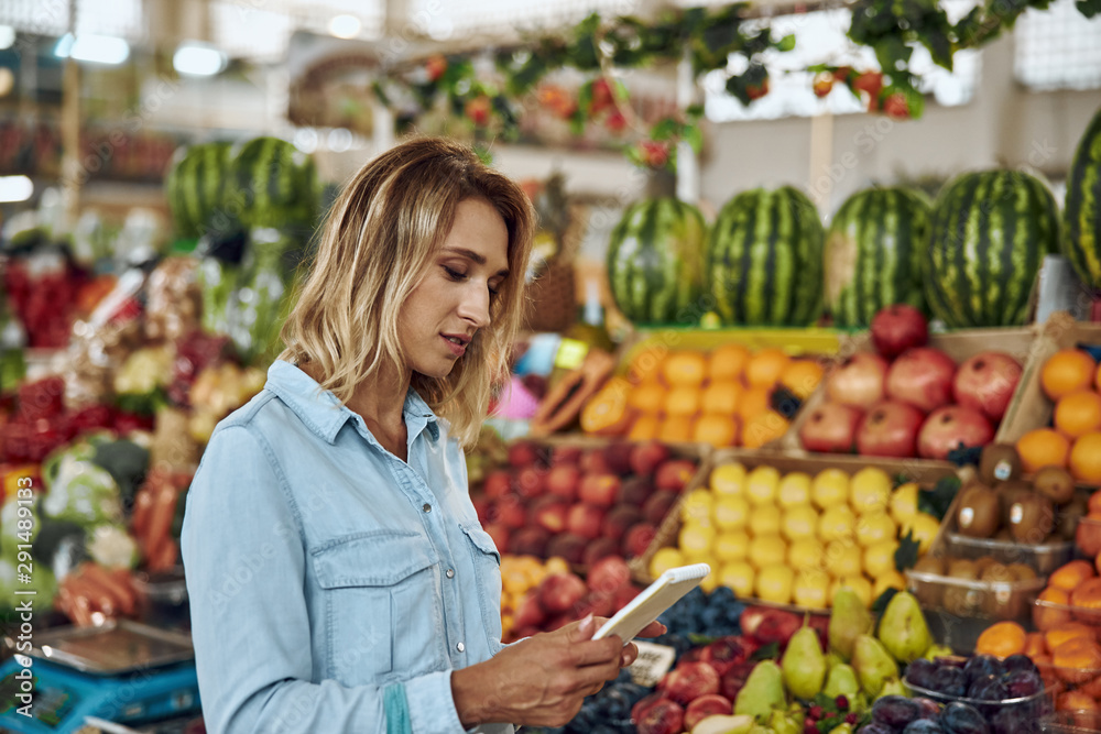 Calm woman with notebook at the market stock photo