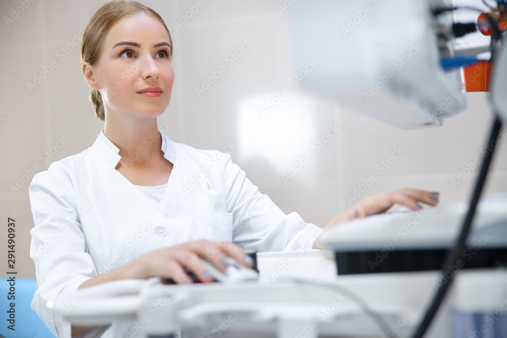 Young doctor working with modern technology in clinic stock photo Young doctor working with modern technology in clinic stock photo