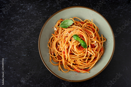 Pasta with tomato sauce on black background