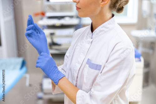 Physician in sterile gloves in office stock photo