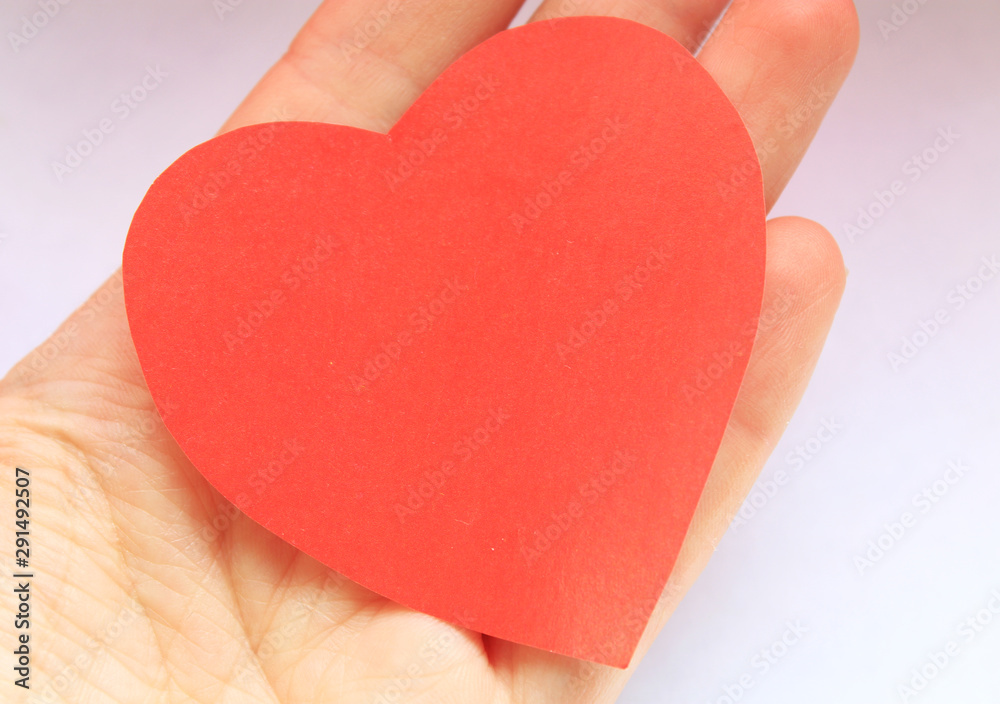 Red paper heart in a man's hand. Red paper heart in a man's hand.