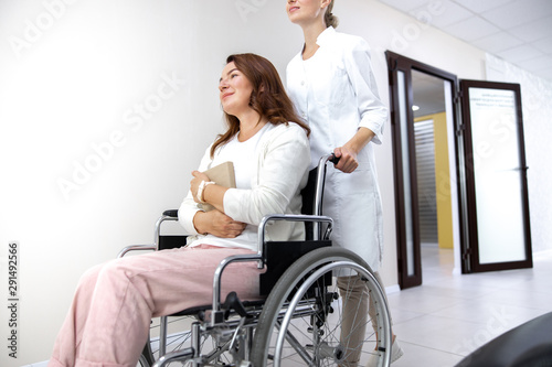 Happy woman on invalid carrige with doctor stock photo photo