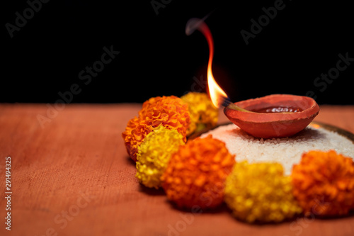 Diya or Terracotta Lamp Traditionally Decorated In Diwali. Diwali Diya, oil lamp beautifully decorated on the festive occasion of deepavali, deepawali. Beautiful stock photo with copy space of diwali  photo