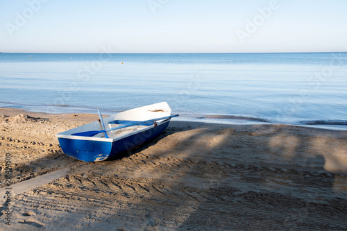 Lonely rowing boat stands on the shore