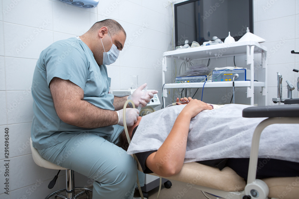 Otolaryngologist examines a young girl Otolaryngologist examines a young girl