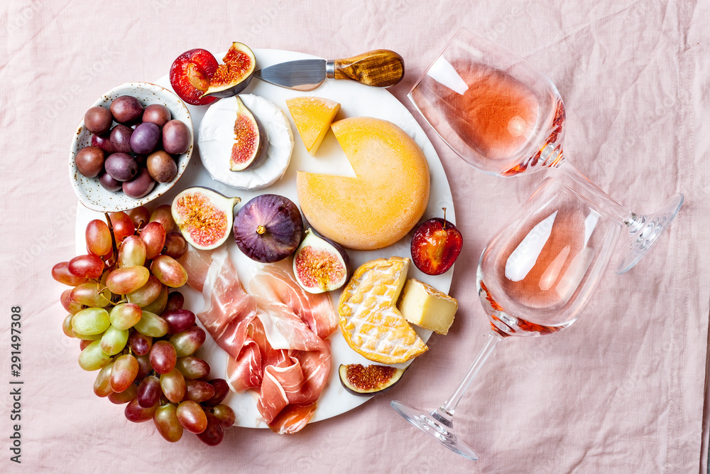 Appetizers, antipasti snacks and rose wine in glasses. Cheese and fruit  platter on marble board over pink linen tablecloth background. Top view  Stock Photo | Adobe Stock