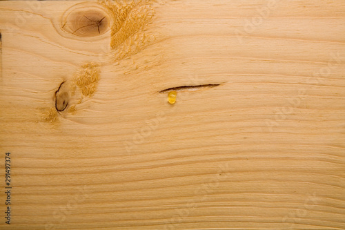 The resin flows over the treated wooden beam.