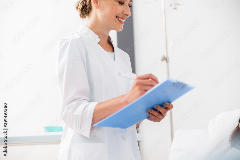 Happy pretty medic is holding form in hospital Happy pretty medic is holding form in hospital