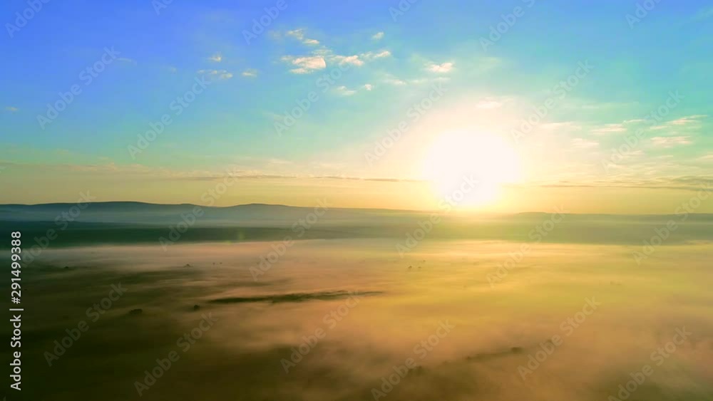 Early morning foggy landscape and movement of fog along horizon line.