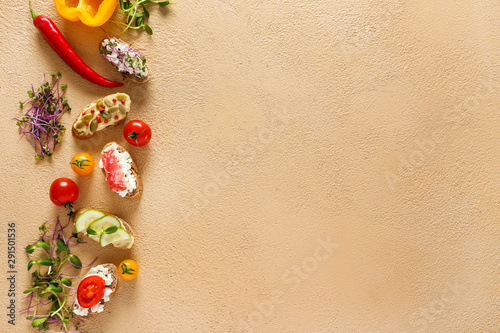 Different tasty sandwiches on color background