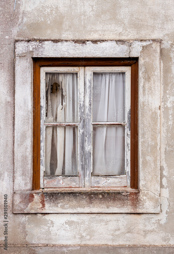 Nazare, Portugal - An old broken window in an abandoned house Nazare, Portugal - An old broken window in an abandoned house