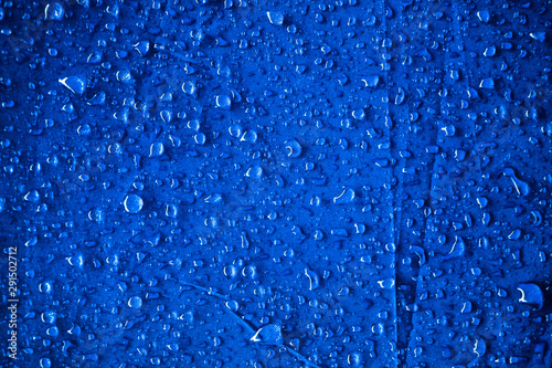 Water drops on the blue fabric.water drops on blue background © rawintanpin