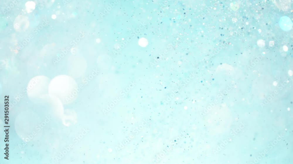 Super slow motion of glittering blue particles. Shallow depth of focus. Filmed on high speed cinema camera, 1000 fps. Super slow motion of glittering blue particles. Shallow depth of focus. Filmed on high speed cinema camera, 1000 fps.