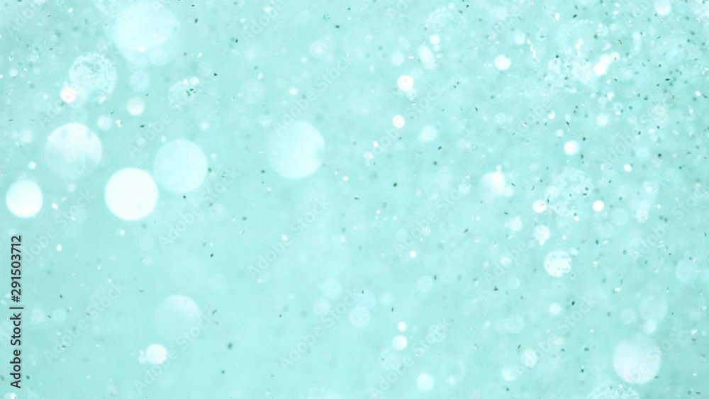 Super slow motion of glittering blue particles. Shallow depth of focus. Filmed on high speed cinema camera, 1000 fps. Super slow motion of glittering blue particles. Shallow depth of focus. Filmed on high speed cinema camera, 1000 fps.