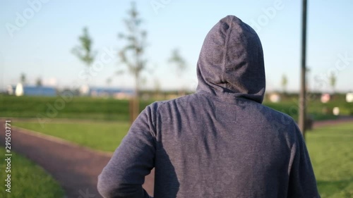 Man running in the park preparing for marathon. Rear view