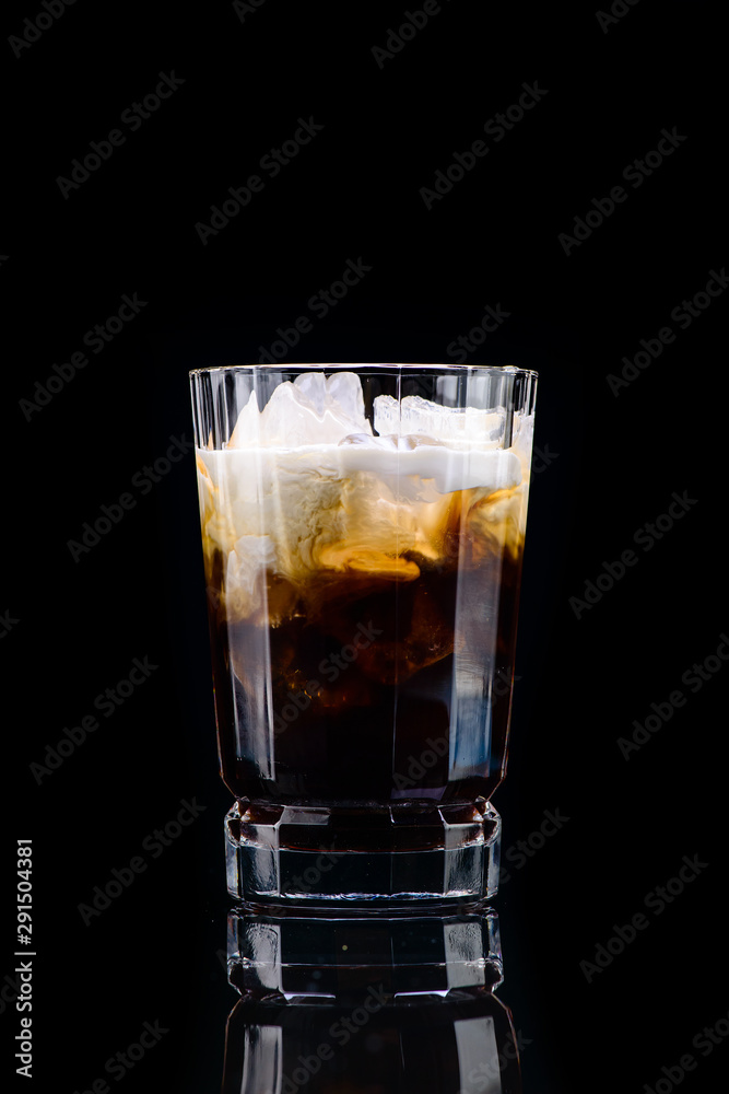classic white Russian cocktail with reflection on a dark background classic white Russian cocktail with reflection on a dark background