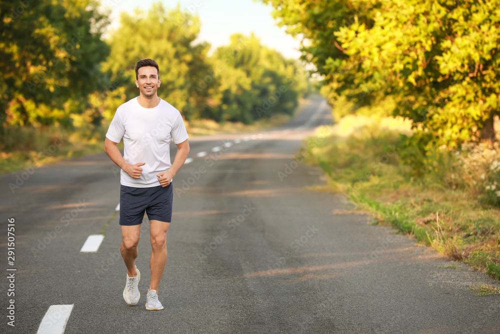 Sporty young man running outdoors